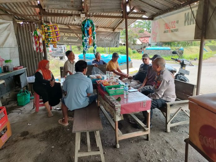 Tampak salah satu anggota kepolisian sedang bersama warga Tampak salah satu anggota kepolisian sedang bersama warga