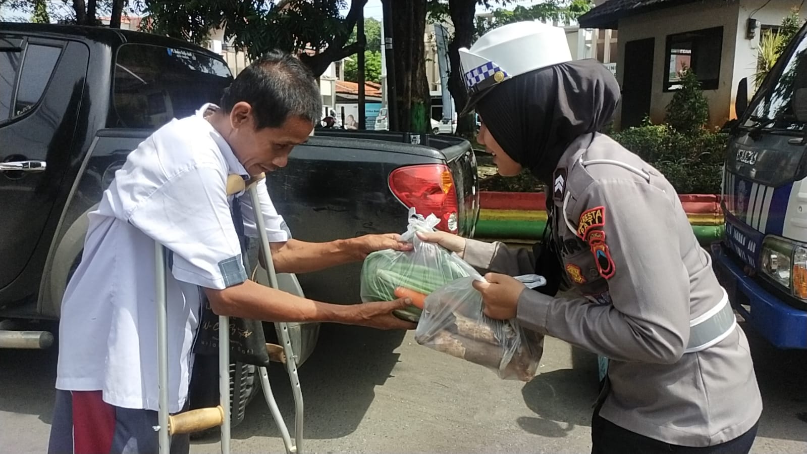 Personel Satlantas Polresta Pati saat membagikan bantuan sayur kepada pengguna jalan, Jumat (14/4/2023)