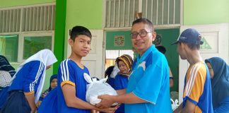 Kepala SMP Negeri 4 Pati (kanan) Mulyono saat memberikan zakat kepada siswa yang kurang mampu, Senin (17/4/2023)