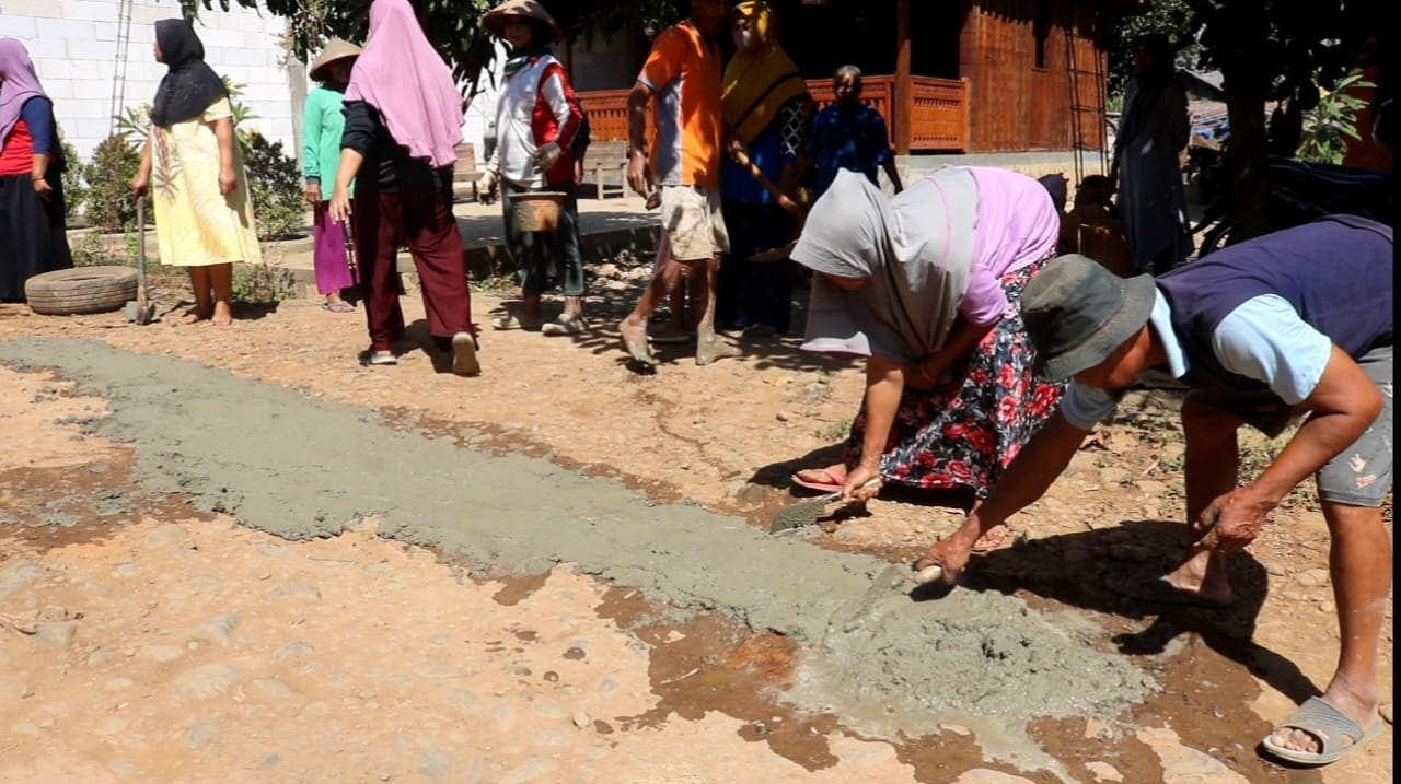 Sejumlah ibu-ibu di Desa Pasucen, Trangkil, tengah menambal jalan dengan semen, sabtu (12/8/2023)